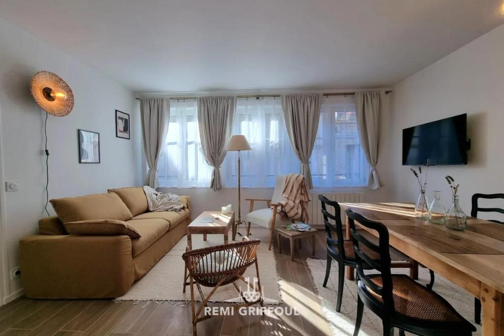 a living room with a couch and a table at La Symphonie Elevator Honfleur City Center 2 Guests in Honfleur