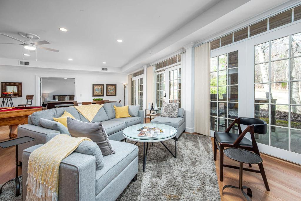 a living room with a couch and a table at The Clubhouse Hideaway - The Greenview Den in Chapel Hill