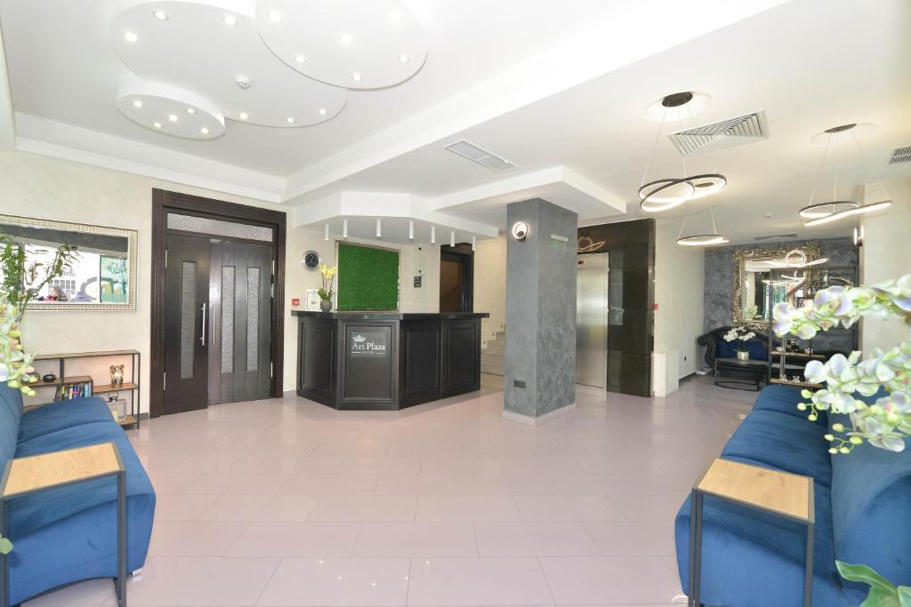 a lobby with two blue chairs and a bar at Art Plaza Hotel in Sofia
