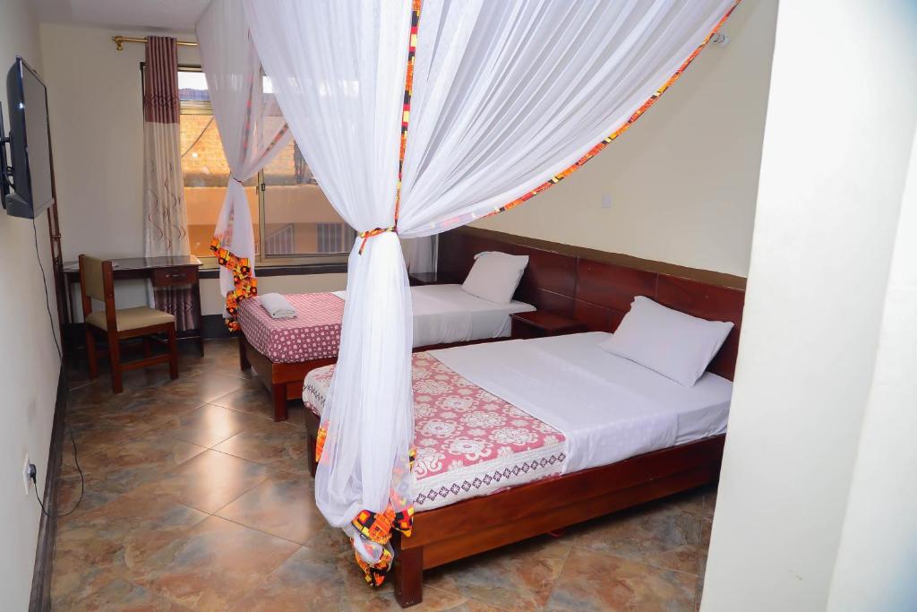 Postel nebo postele na pokoji v ubytování Hotel Acacia View