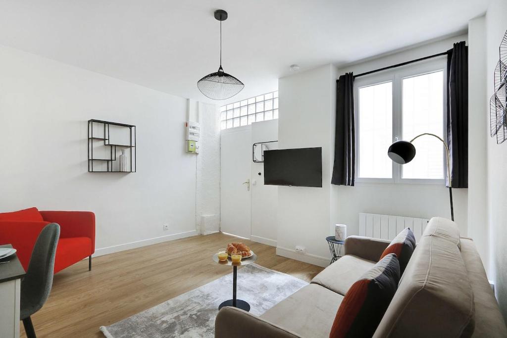 un salon blanc avec un canapé et une télévision dans l'établissement A0# Republic # Marais # 1BedRoom # Paris03 # AC, à Paris