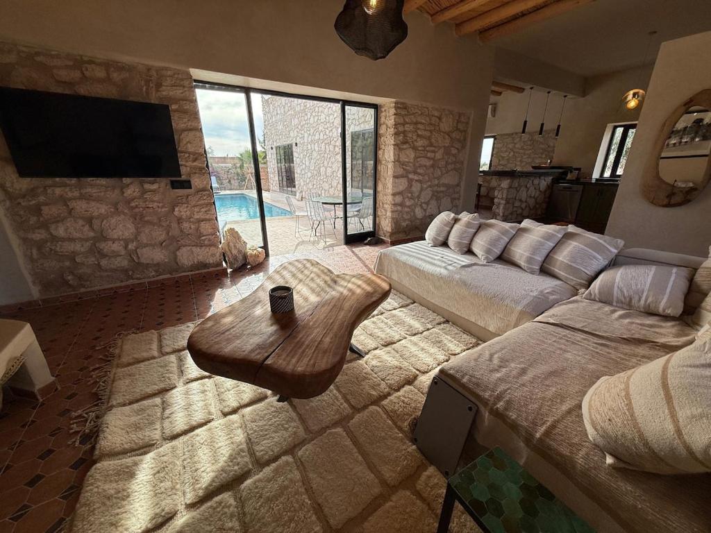 a living room with a couch and a table at La Pausa du Douar in Essaouira