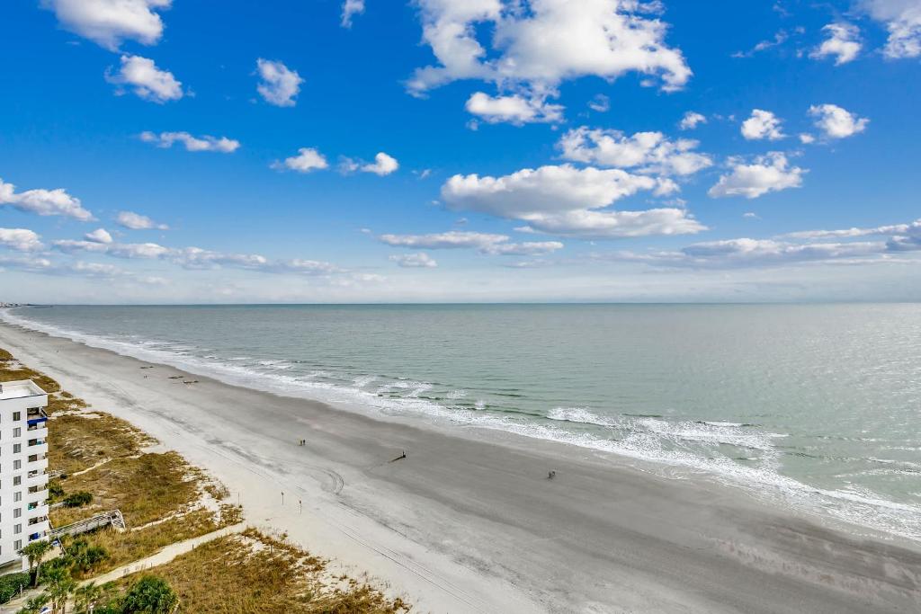 an aerial view of a beach with people on it at Oceanfront TOP LOCATION MODERN RESORT Lazy River Huge Pool Oasis in Myrtle Beach