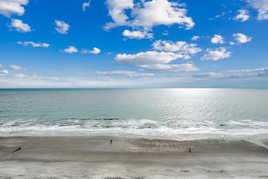 a view of the ocean with people on the beach at Oceanfront TOP LOCATION MODERN RESORT Lazy River Huge Pool Oasis in Myrtle Beach
