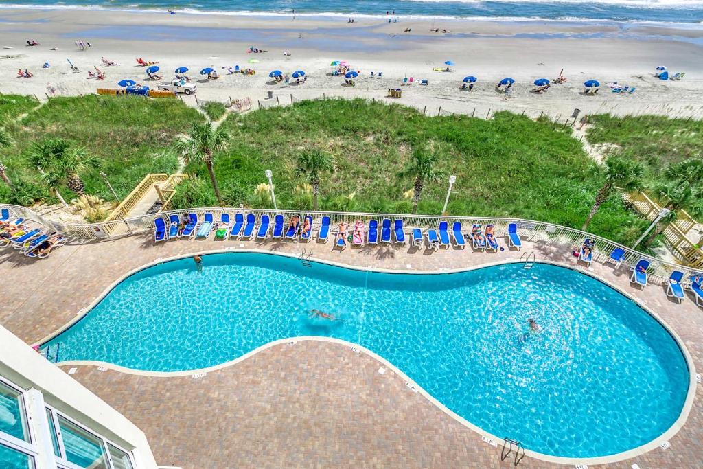 an overhead view of a swimming pool next to a beach at Oceanfront TOP LOCATION MODERN RESORT Lazy River Huge Pool Oasis in Myrtle Beach