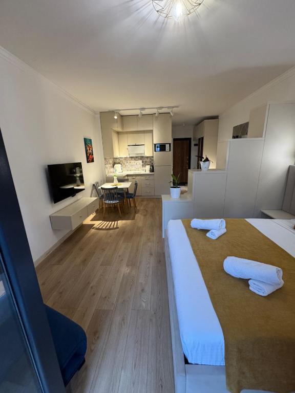 a bedroom with two beds and a living room at Moonlight Apart-Hotel Batumi in Batumi