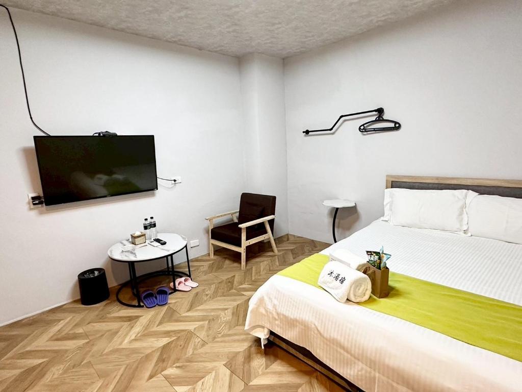Postel nebo postele na pokoji v ubytování 希沐溫泉行旅