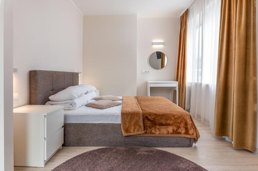 a bedroom with a bed and a mirror at 11B Svečių namai Palanga in Palanga