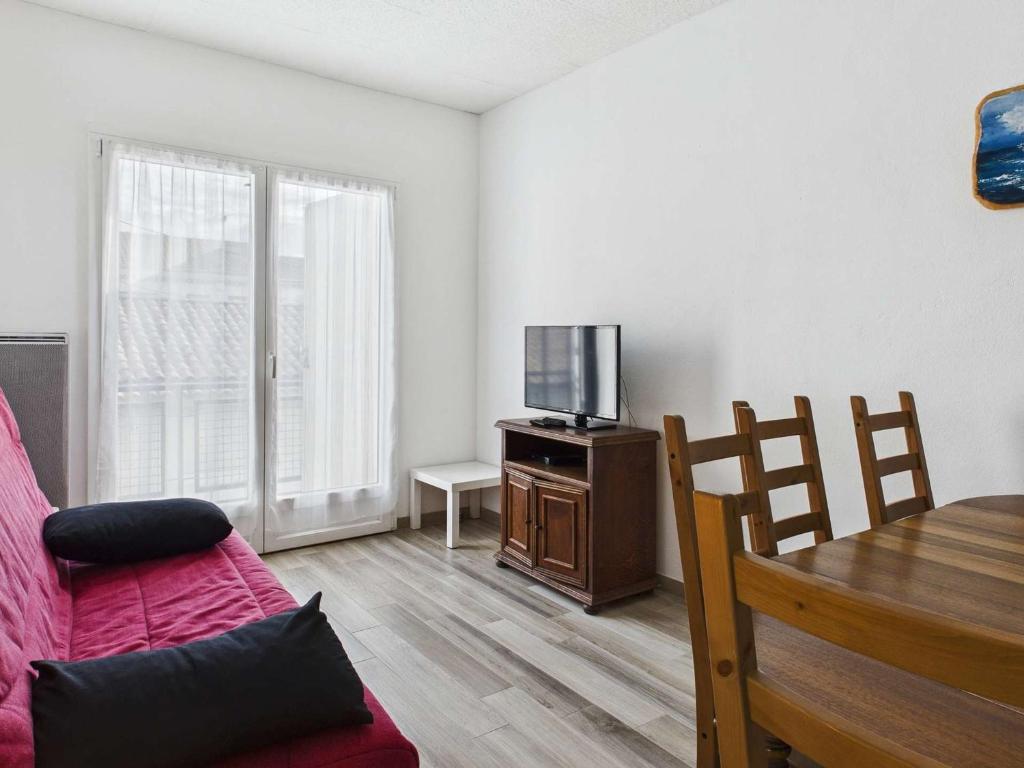 un salon avec un canapé, une télévision et une table dans l'établissement Appartement 3 pièces proche plage et commerces, 6 couchages, balcon – Agde - FR-1-423-198, au Grau-dʼAgde