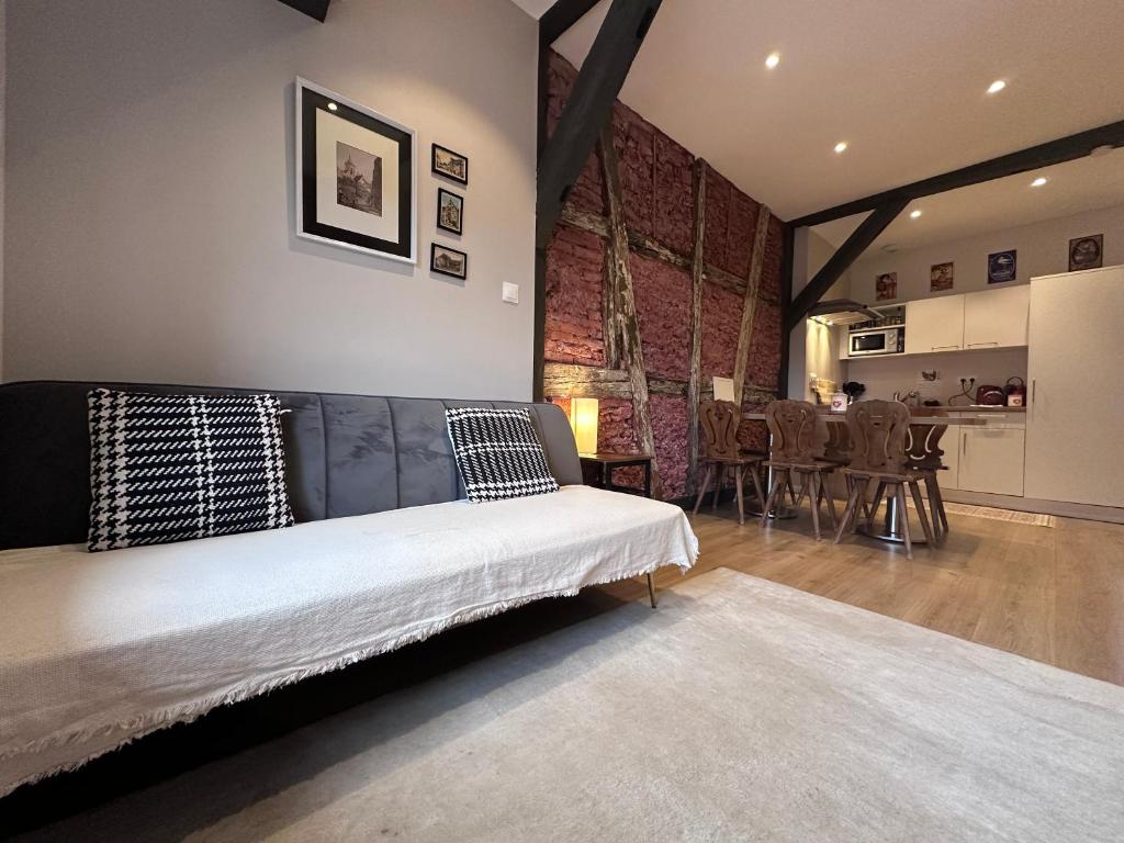 a bedroom with a bed and a dining room at B'm Gretel - Duplex 4 pers - Vue Cathédrale - Centre Historique in Colmar