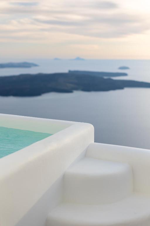 an aerial view of the ocean from an airplane wing at Surupo Suites in Imerovigli
