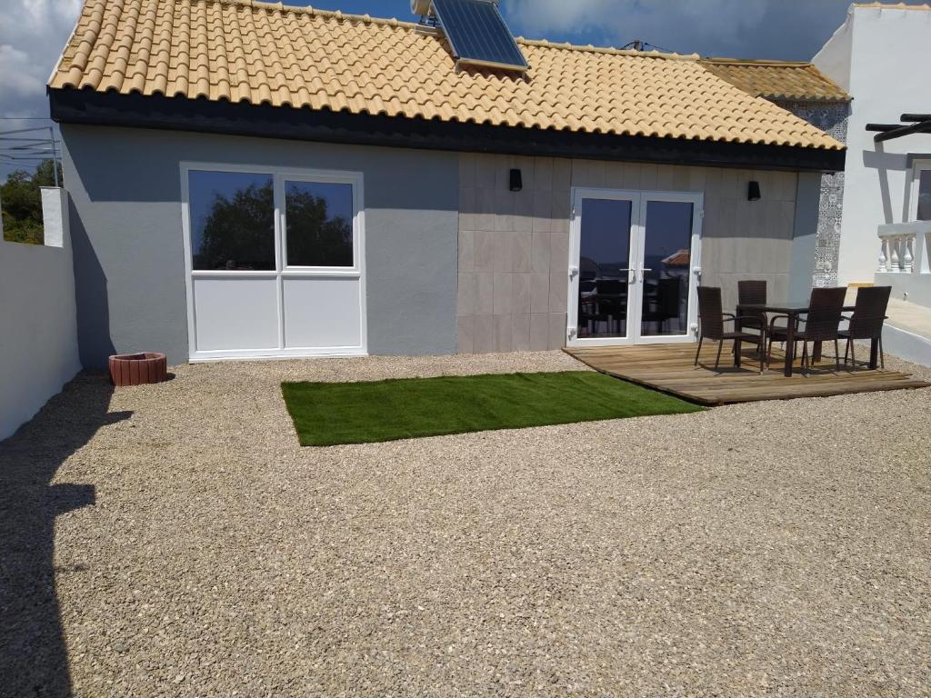 a house with a patio and a table and chairs at Guesthouse Vista dos Cerros in Loulé