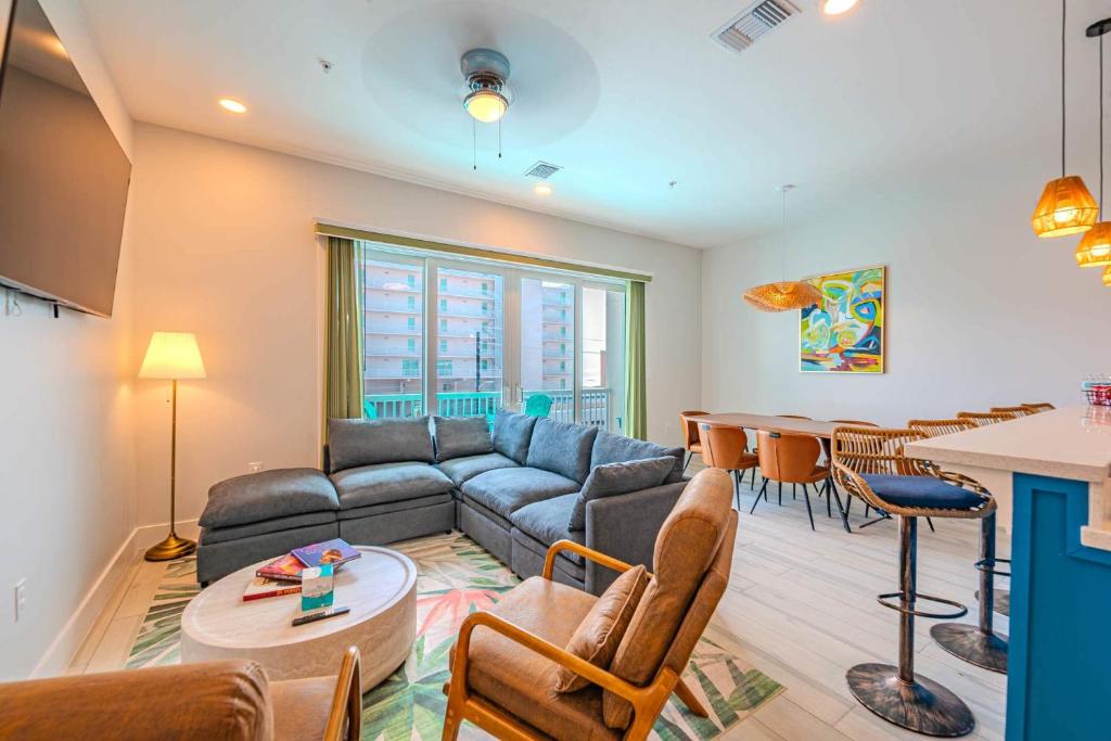 a living room with a couch and a table at Palm Paradise in South Padre Island