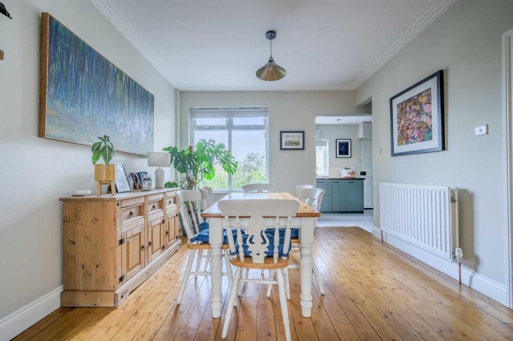 a kitchen and dining room with a table and chairs at Grove Getaway Walk To The Beach & Ballyholme in Bangor