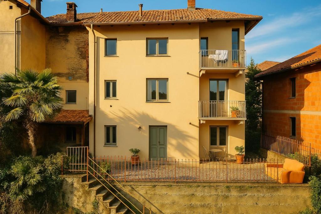 a large house with a staircase in front of it at Casa Zuccaro in Valduggia