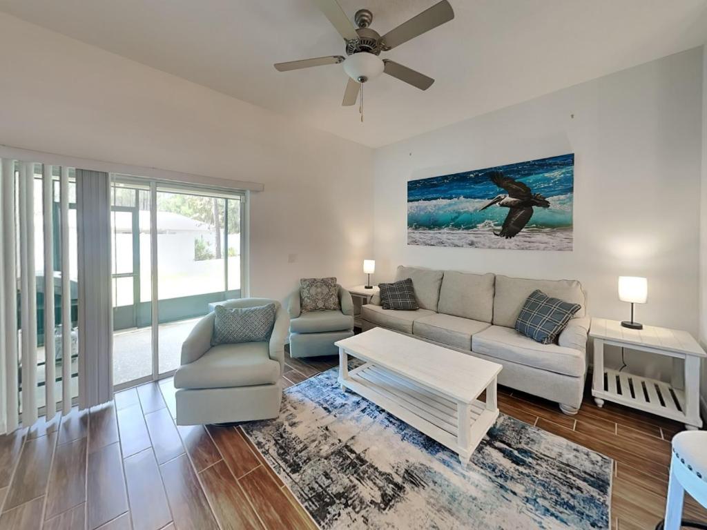 a living room with a couch and a table at Breezy Villa in Palm Coast