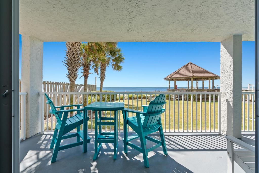 a porch with a table and chairs and a gazebo at Romar Tower Unit 1A in Orange Beach