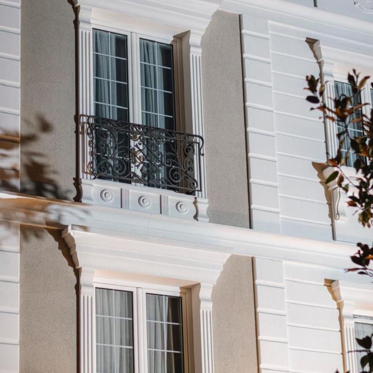 a window on a building with a balcony at Oxygen Boutique Hotel in Tirana