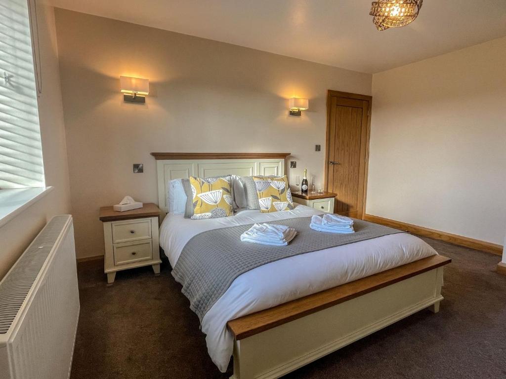 En eller flere senge i et værelse på Branwen Holiday Cottage