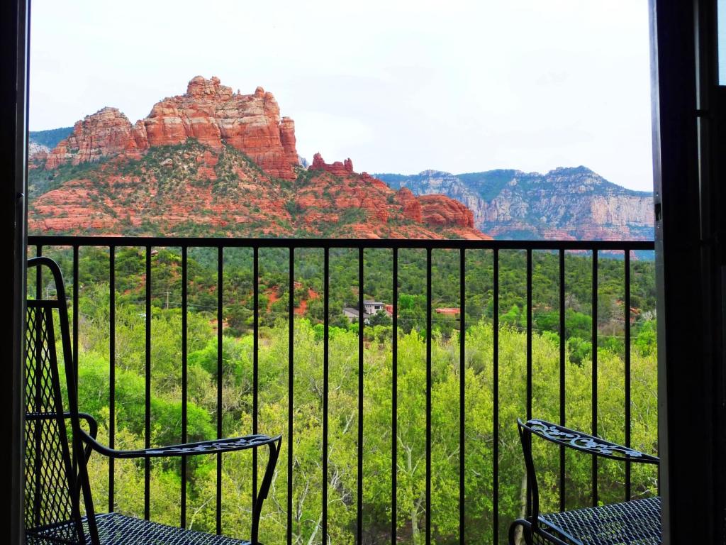two chairs on a balcony with a view of mountains at Cedars Resort in Sedona