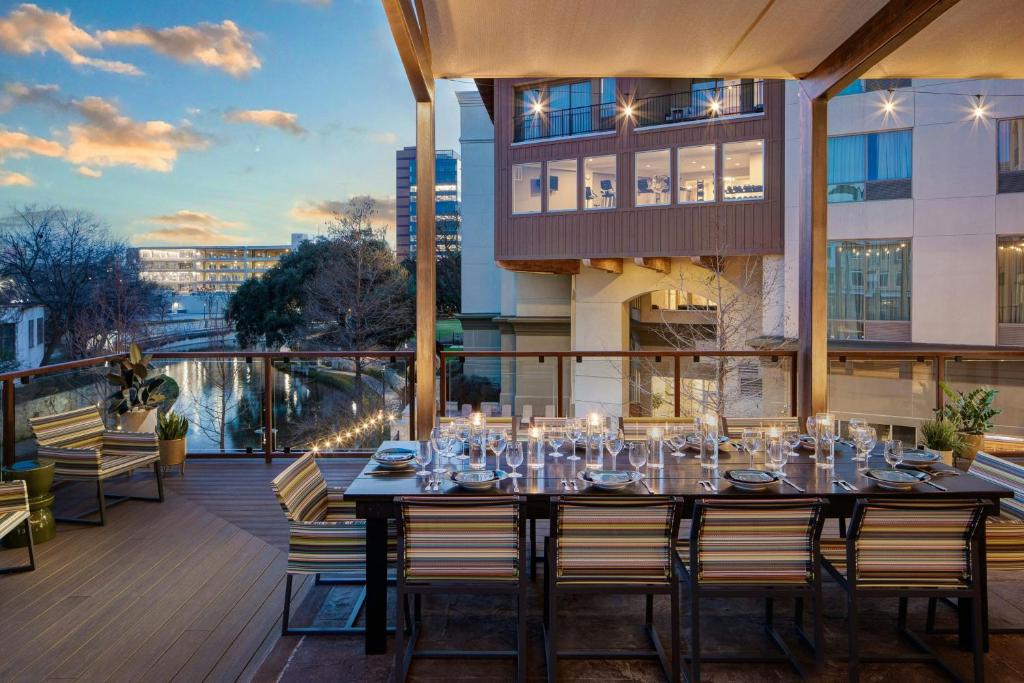 a dining table on the balcony of a building at Sol Cypress, San Antonio, a Tribute Portfolio Hotel in San Antonio