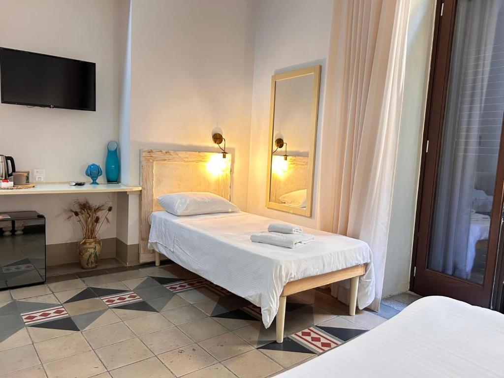 Postel nebo postele na pokoji v ubytování Damasa Rooms