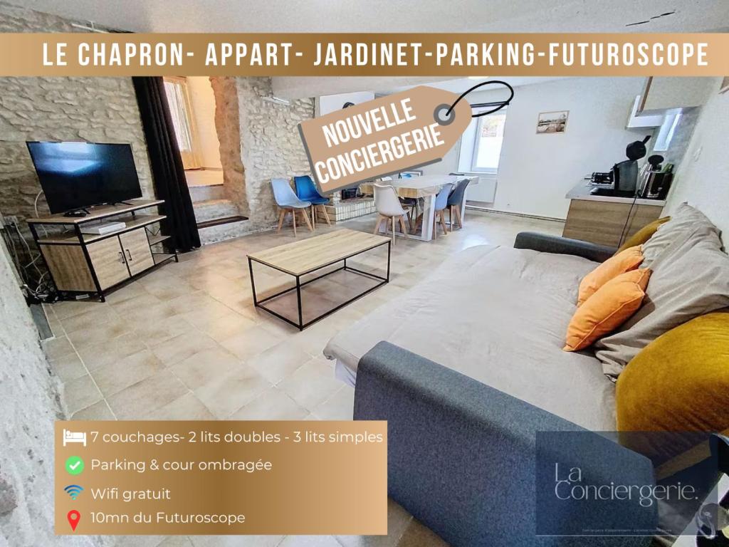 a living room with a couch and a table at La Maison du Chapron - Jaunay Marigny - Futuroscope in Jaunay-Marigny