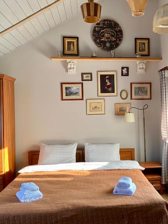 a bedroom with a bed with two towels on it at Vila Fortuna - Art O'Clock in Sibiu