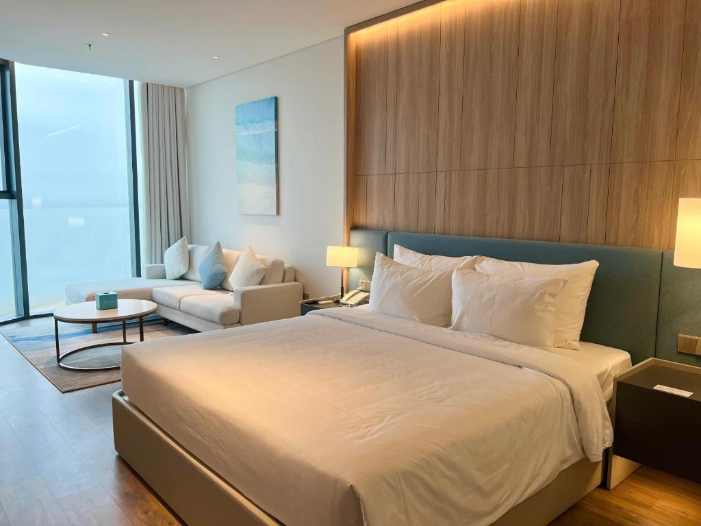Postel nebo postele na pokoji v ubytování Lotus Alacarte Hạ Long Hotel