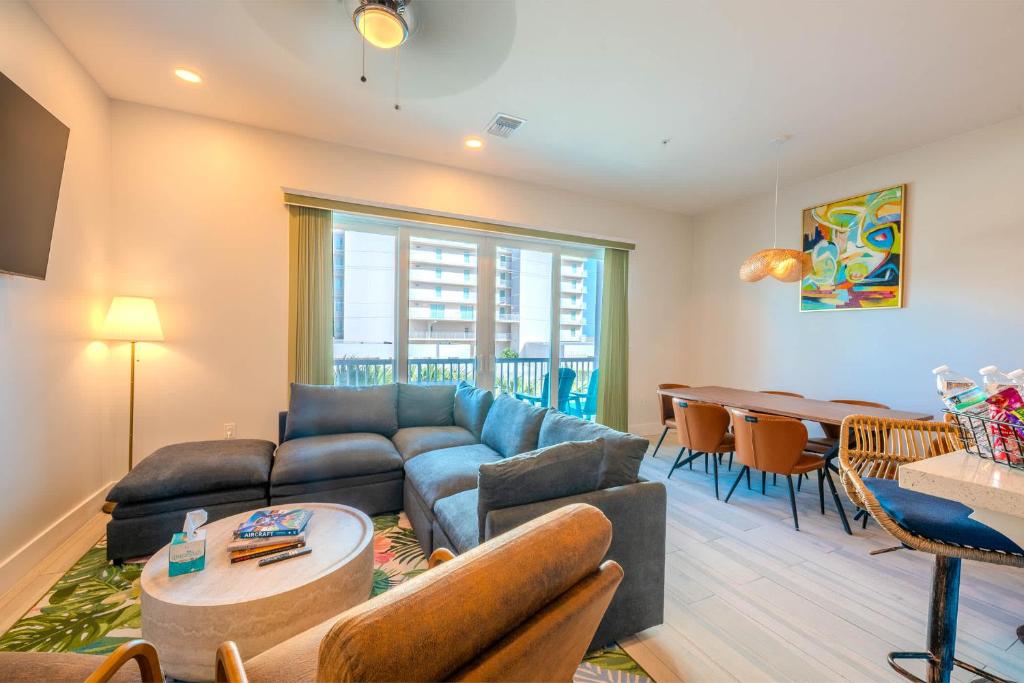 a living room with a couch and a table at Surfside Sanctuary in South Padre Island