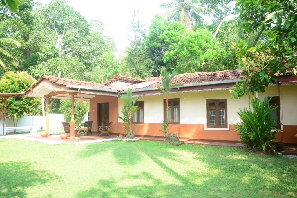 a house with a yard in front of it at Serene Lodge in Gampaha
