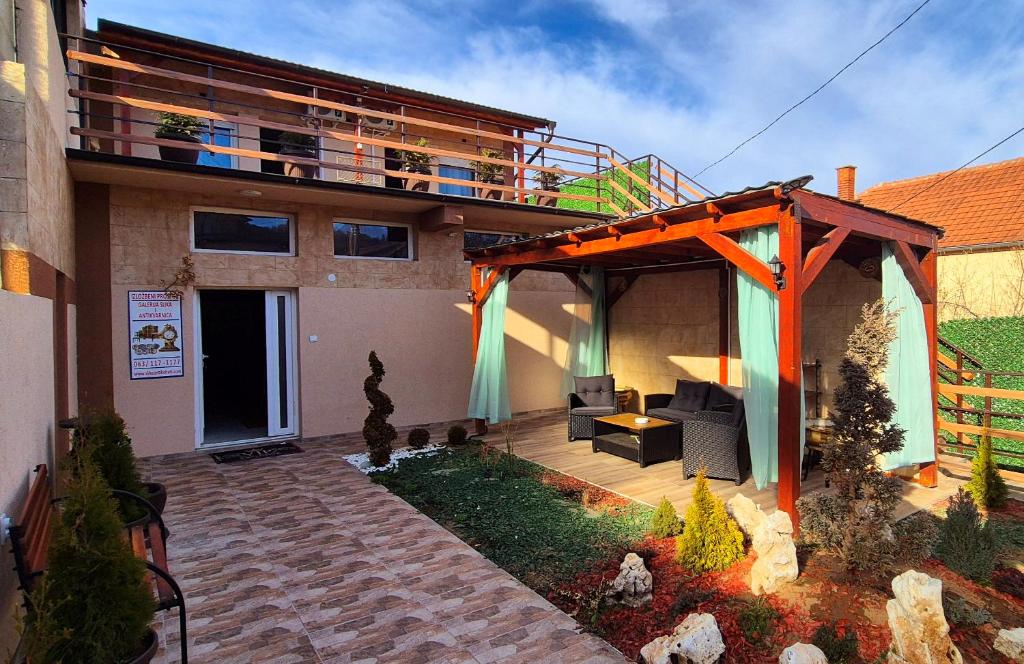 a house with a pergola and a patio at Apartmani IMW in Zaječar
