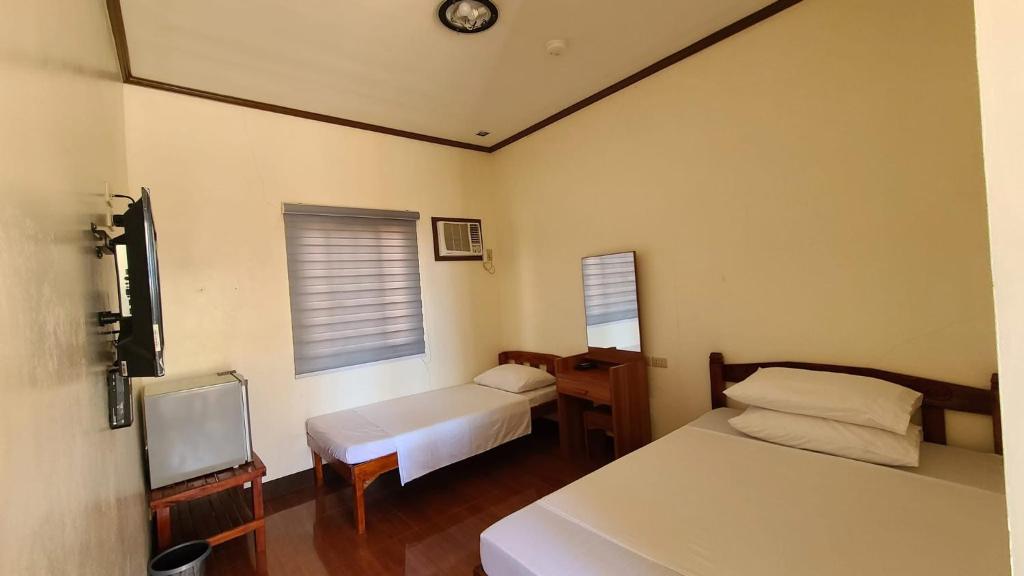 Postel nebo postele na pokoji v ubytování NSZ Beachline Resort