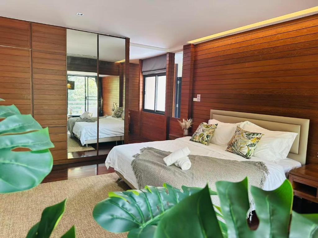 a bedroom with a large bed and a mirror at 5BR Villa with Private Pool Sukhumvit 10mins BTS in Bangkok