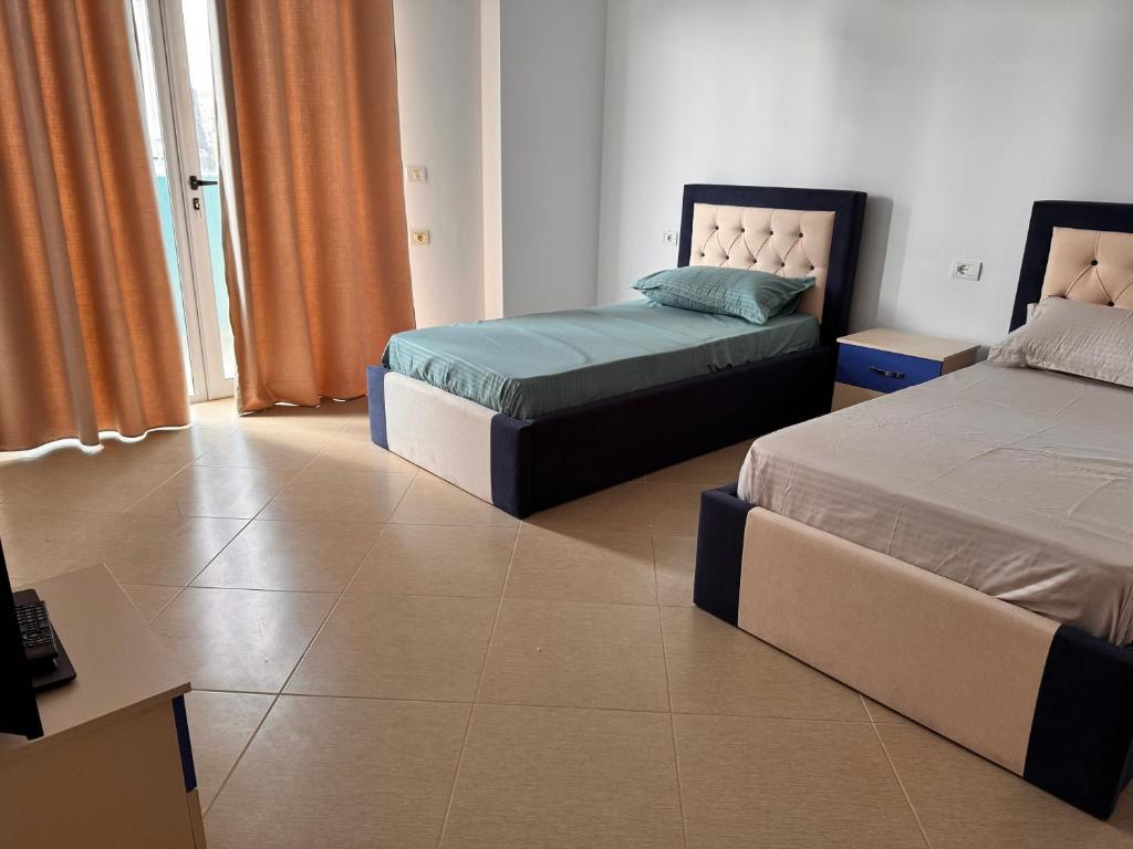 Postel nebo postele na pokoji v ubytování Arena Apartment Elbasan