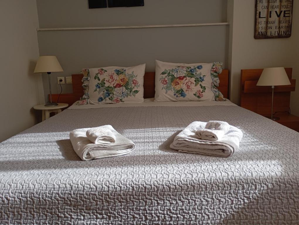 two towels on a bed with two pillows at Volos Seaside Studio in Volos