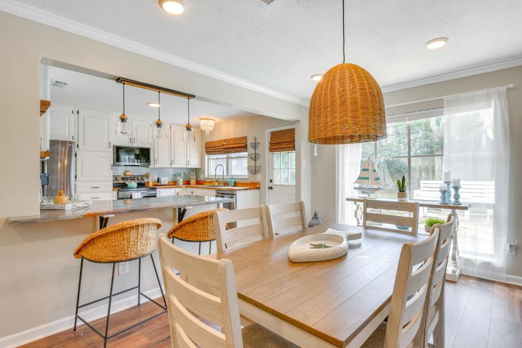 a kitchen and dining room with a wooden table and chairs at 2 Mi to Shore Modern Retreat in Fort Walton Beach in Fort Walton Beach