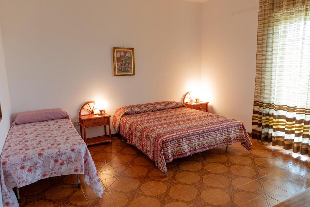 Postel nebo postele na pokoji v ubytování Cinzia House