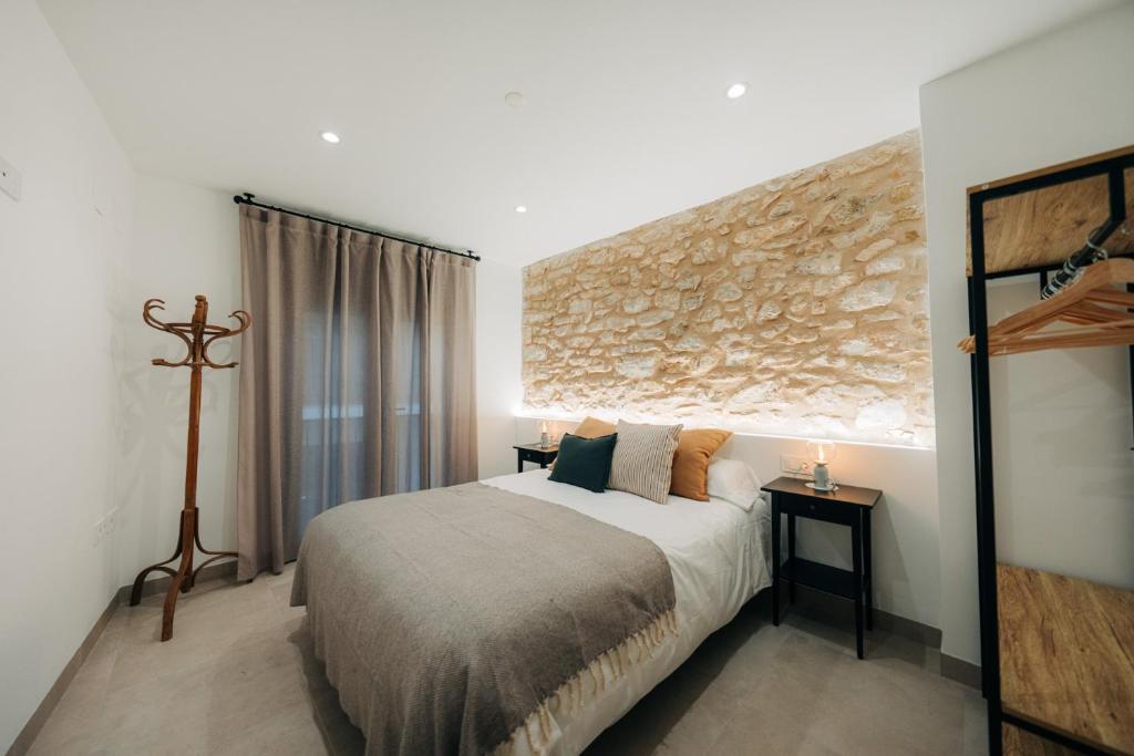 a bedroom with a large bed and a window at Casa Els Pardos - Allotjament Rural in Adzaneta