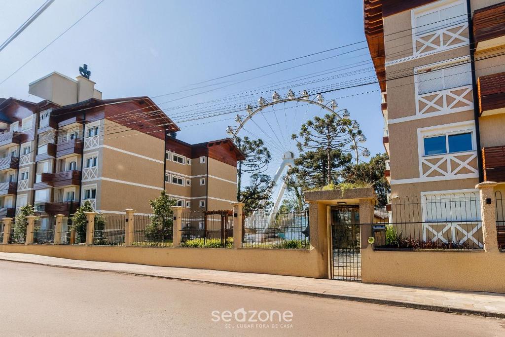 an empty street with a ferris wheel in the background at Lindo Apto c/ 2 Quartos em Canela DAL207 in Canela