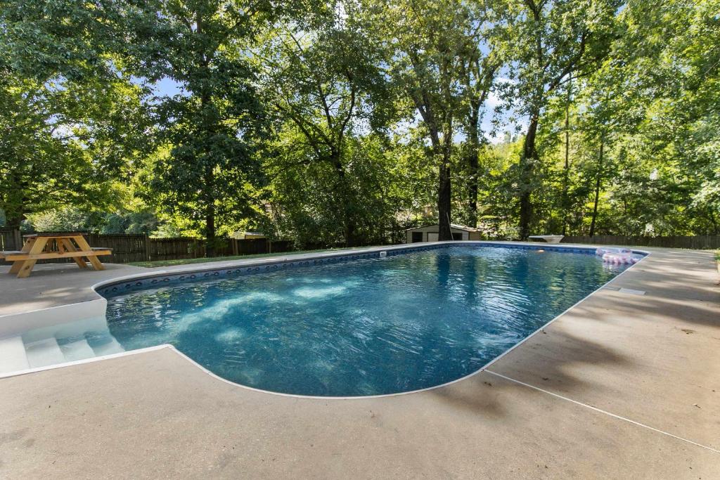 a swimming pool in a yard with trees at Two Kitchens Family Friendly in Forestdale in Birmingham