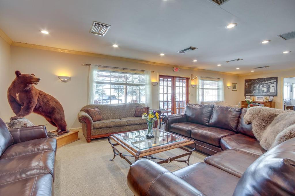 a living room with couches and a bear statue at Views and Trail Access Scenic Montana Ranch Retreat in Emigrant