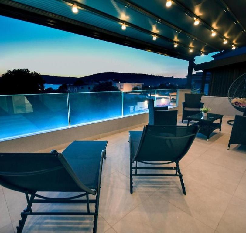 a group of chairs sitting on a patio at night at Relax House Kanica in Zaglavice