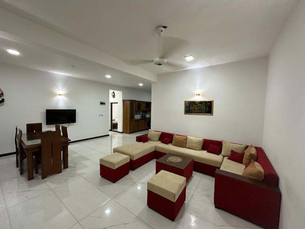 a living room with a couch and a table at Fedro Apartments in Negombo