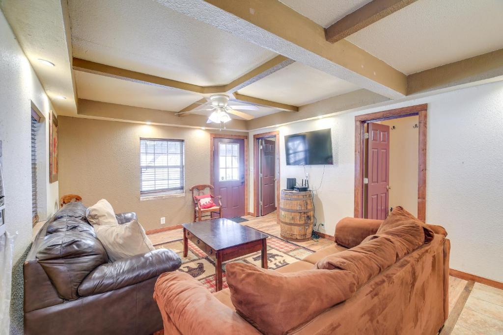 a living room with a couch and a table at Near Riding Trails for ATVs Cabin in Delbarton in Delbarton