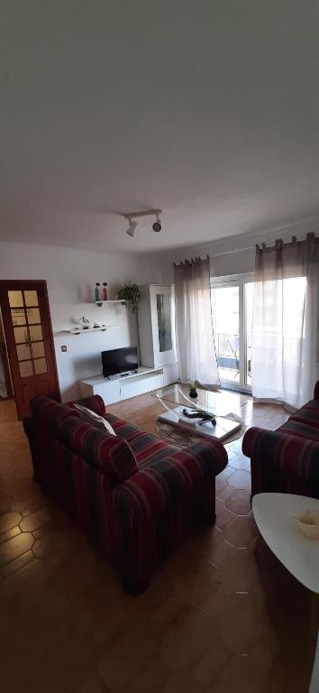 a living room with a couch and a table at Buarcos Beach House in Buarcos