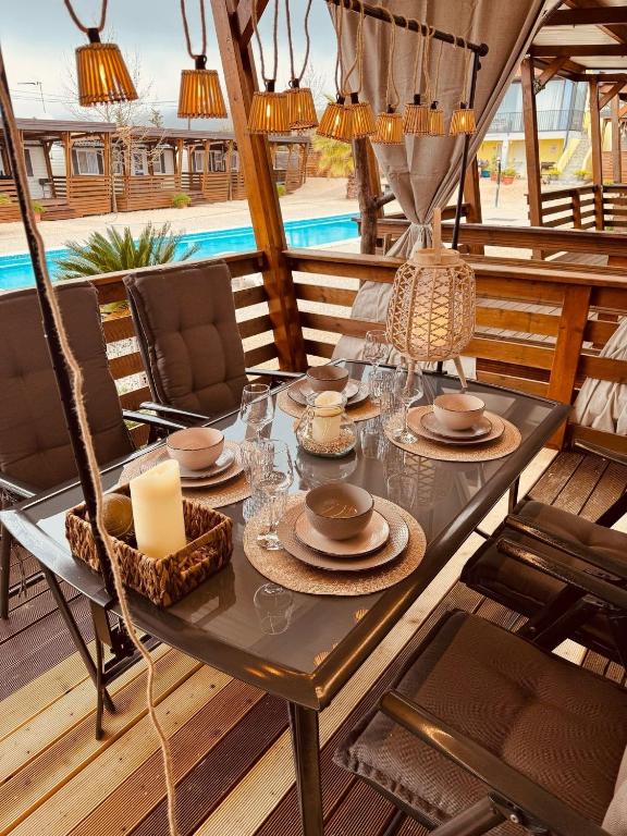 a patio with a table and chairs and a pool at Casabella Turanj in Turanj