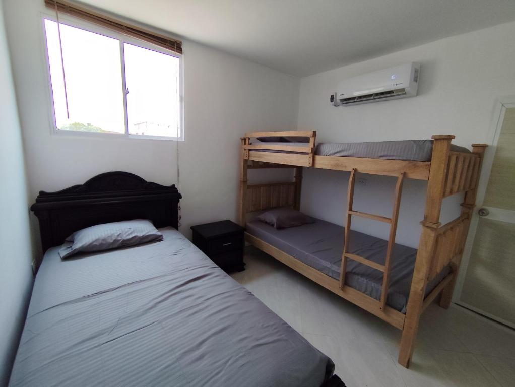 a bedroom with two bunk beds and a window at CasaCabaña in Santa Marta