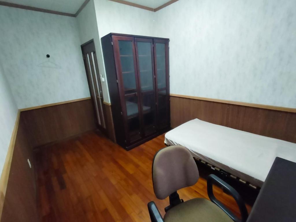 a room with a bed and a chair and a door at Kanupata - Vacation STAY 18614 in Ishigaki Island