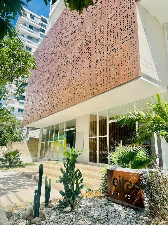 a building with a bunch of cactuses in front of it at Eira: Luxury and Serenity by the Sea in Santa Marta in El Prado